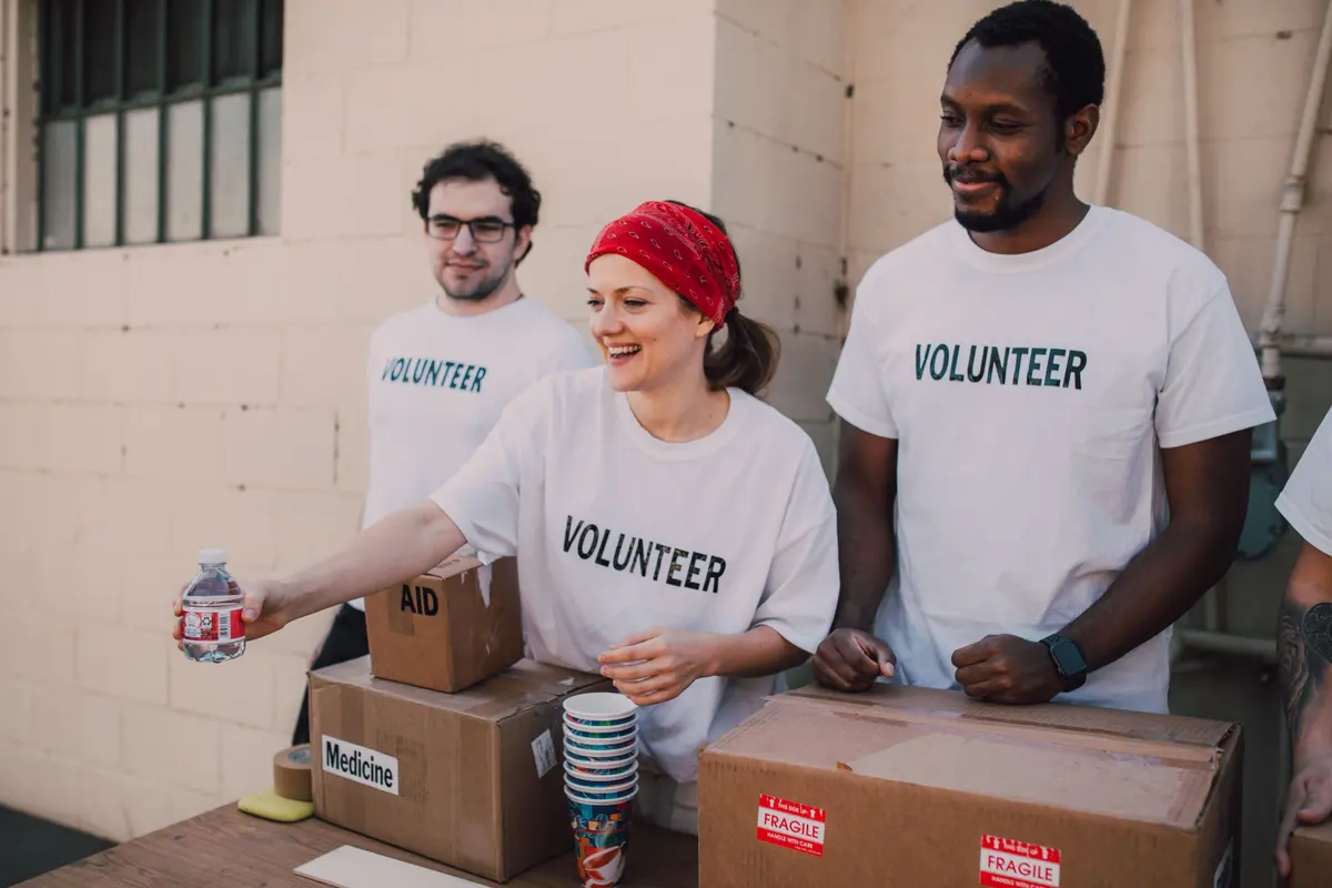 Volunteers packing aid and medicine supplies at a community distribution point